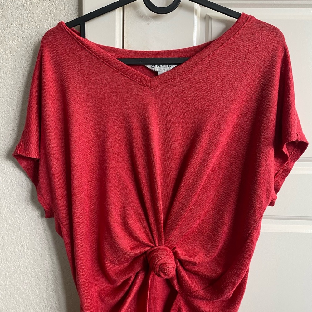 Red shirt, tied or untied. V neck